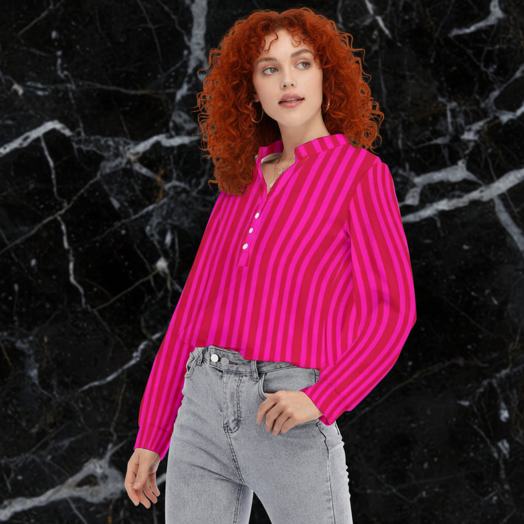 A woman wearing a pink and red striped button shirt