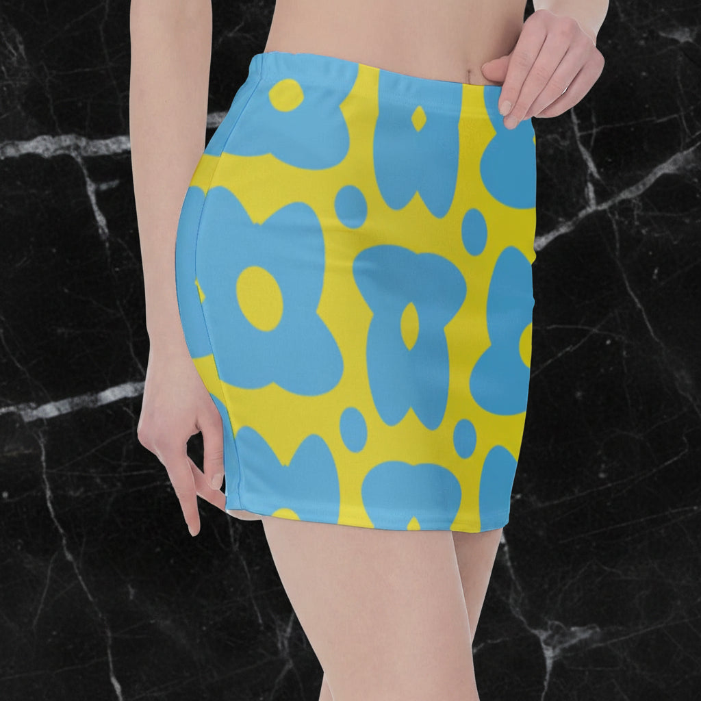 A side view of a yellow skirt with blue cartoon flowers.