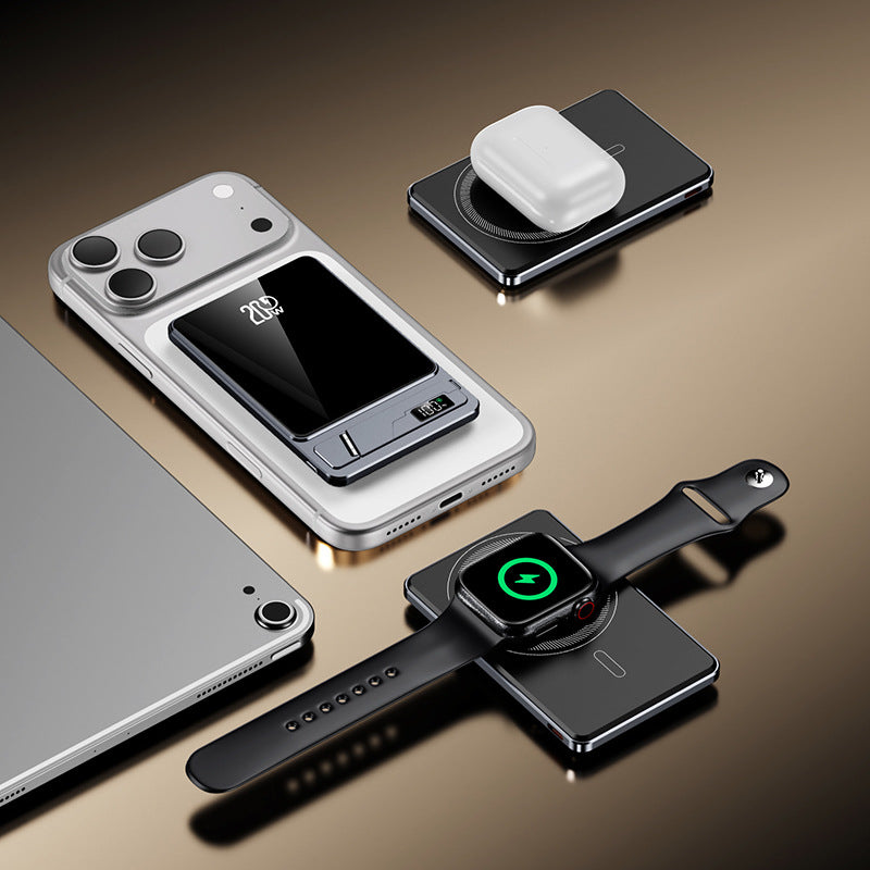 Smartphone, smartwatch, and wireless charging pad on surface
